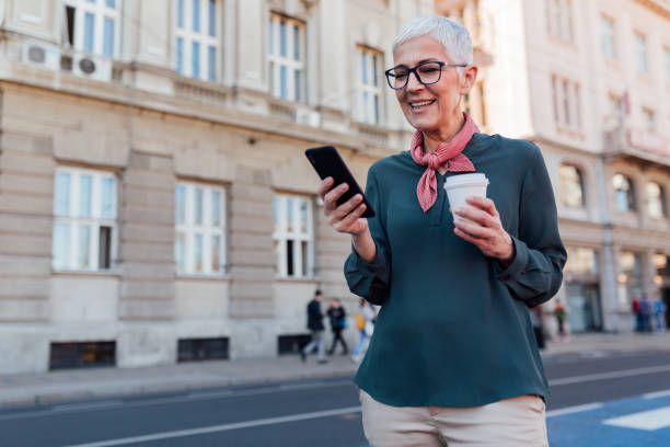 istock Happy senior woman using her smart phone 1251586036