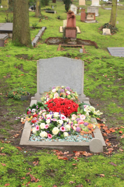istock Funeral flowers on a grave 1251586875