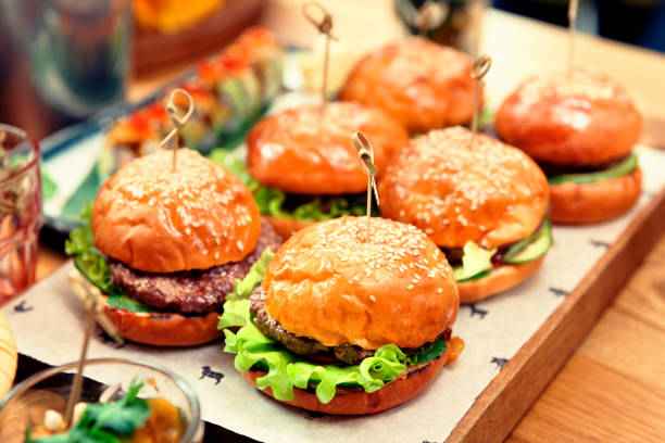 istock Hamburgers on wooden board, toned 1251586882