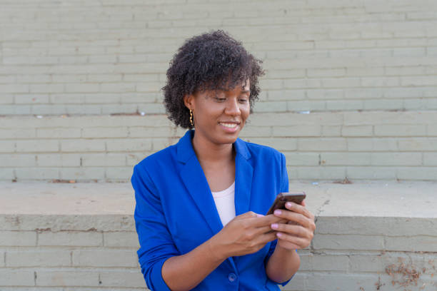 istock Young woman using mobile at street 1251587341