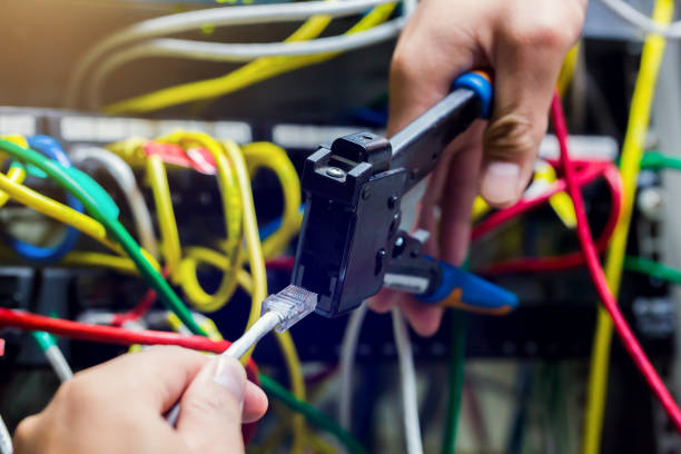istock Selective focus to RJ45 Connector with crimping RJ45 tool on blurry background of UTP cable and computer network in computer room. 1251588059
