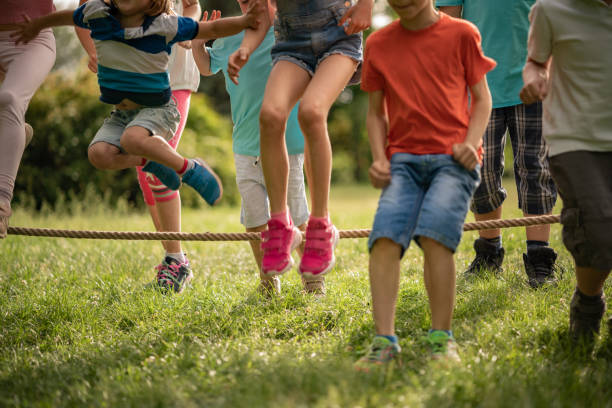 istock Kids jumping over a rope 1251588525