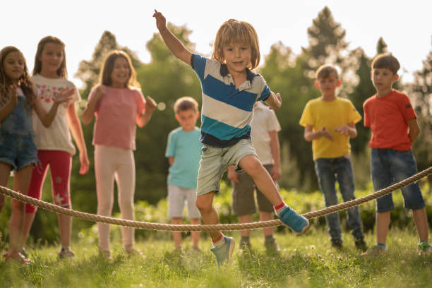istock Little boy is jumping over a rope in nature 1251589939