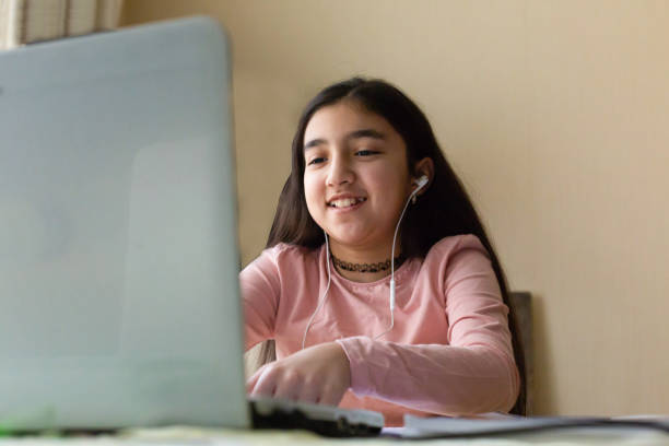 istock Happy girl enjoying e-learning, chatting with friends over internet, video conference 1251591575