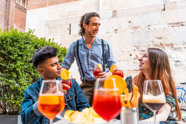 istock Friends drinking colored cocktail at outdoor 1251592882