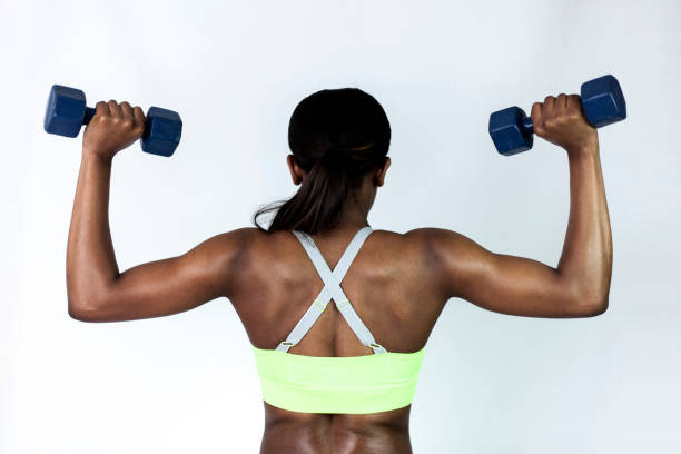 istock Unrecognizable black woman working out her back lifting free weights 1251592994