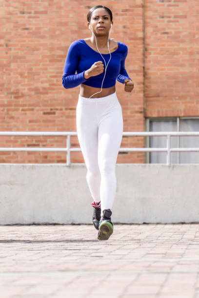 istock Focused black young woman running outside 1251593002