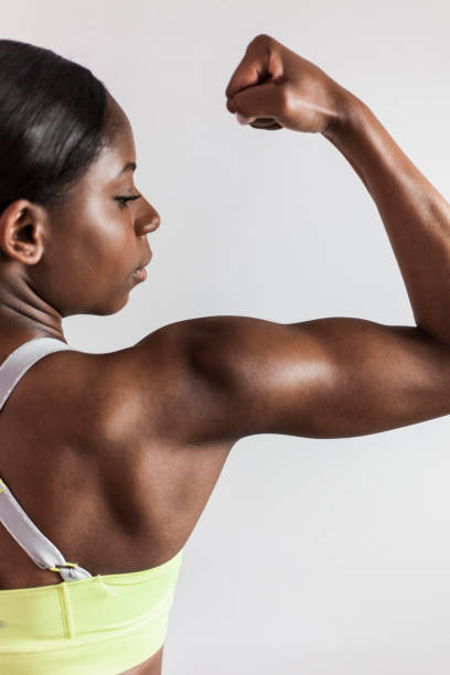 istock Strong black fit woman showing her biceps 1251593011