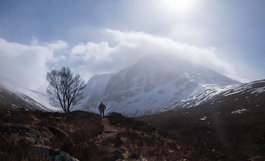 Incredible view to the Ben Nevis mount - is the highest mountain in the British Isles. Alone traveler backpacker hiking on moorland in Highlands, Scotland, UK