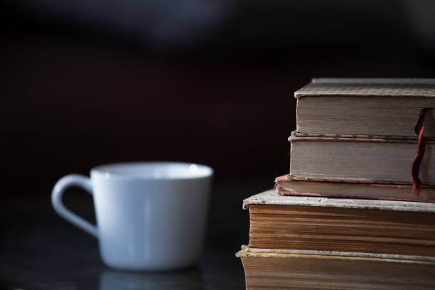 istock A stack of old books with a white cup next to it 1251596251
