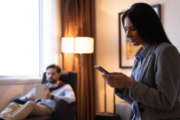 istock Pleasant young couple spending time online in a hotel room 1251596480