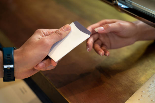 istock Hotel administrator passing a key to a guest 1251596605