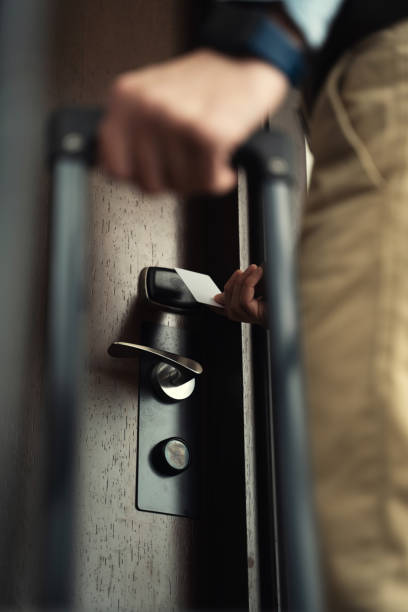 Guest with a baggage unlocking hotel suite with electronic key