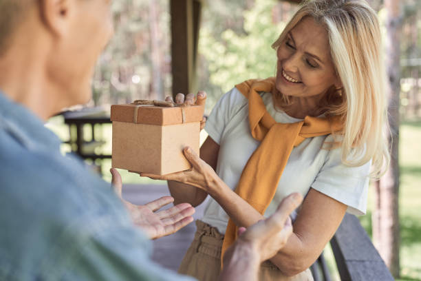 istock Happy woman getting gift in box from husband 1251602917