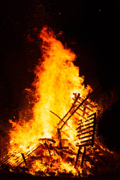 istock Burning woods with fire sparks, flame and smoke at night fireplace. 1251607397