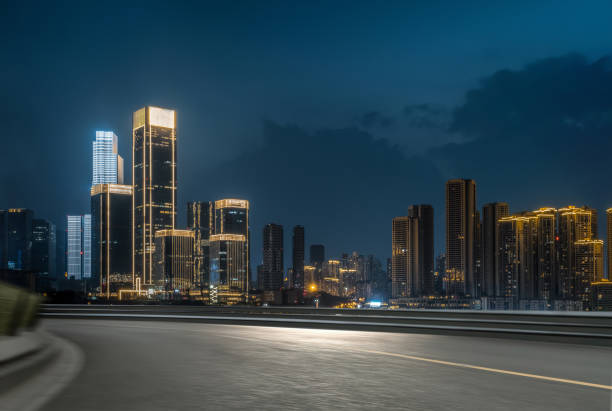 istock empty asphalt road in downtown with illuminated modern cityscape and buildings at night. 1251608930