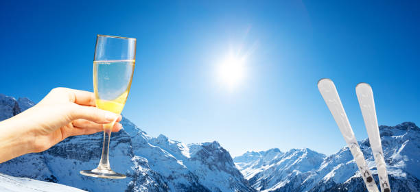 istock Ski and hand hold champagne over the mountains 1251611719
