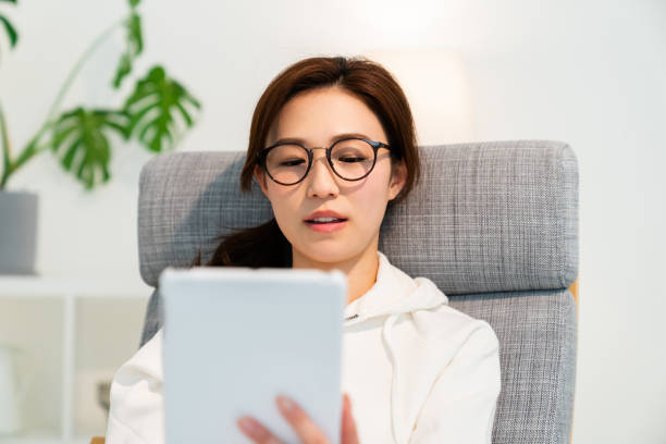 istock asian woman to see a tablet computer 1251620841