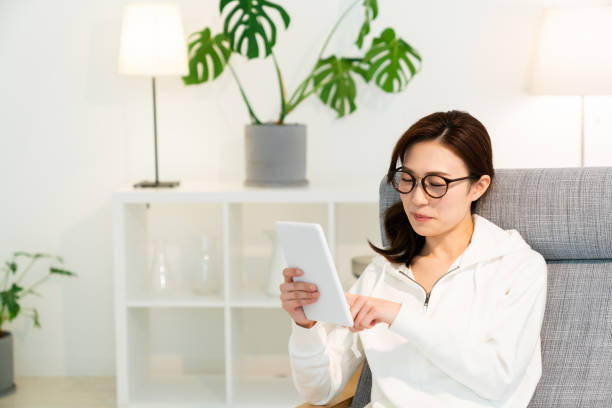 istock asian woman to see a tablet computer 1251620853