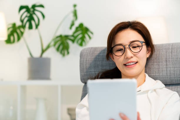 istock asian woman to see a tablet computer 1251620860