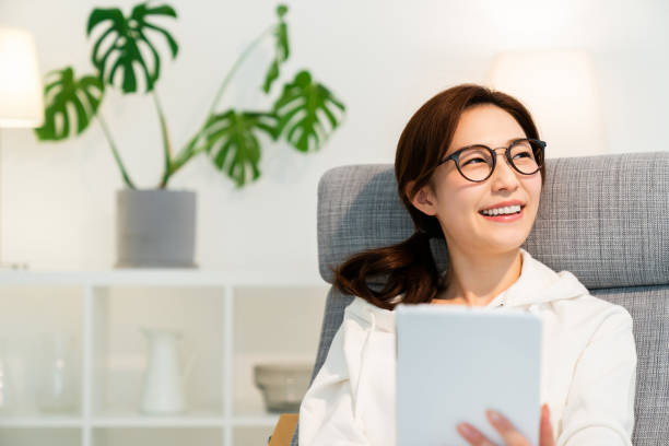 istock asian woman to see a tablet computer 1251620888