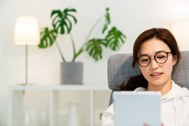 istock asian woman to see a tablet computer 1251620914