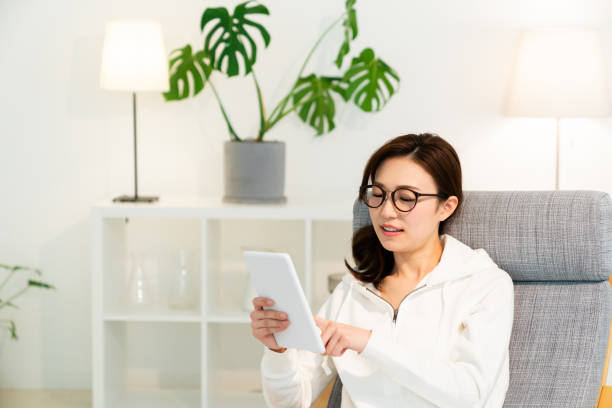 istock asian woman to see a tablet computer 1251620922