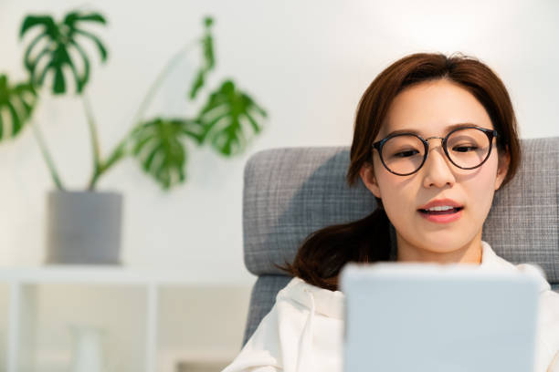 istock asian woman to see a tablet computer 1251620928