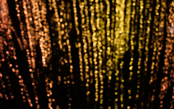 istock Yellow and red blurred bokeh background at the dark. 1251622242