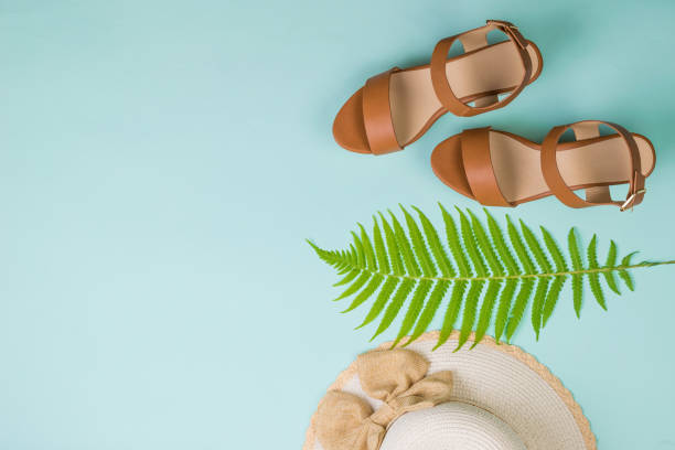 istock Women's hat, leaf and sandals on a blue background. The view from the top. 1251627945