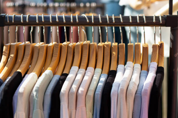 istock Multi-colored women's sweaters hang on wooden hangers close-up. 1251629842