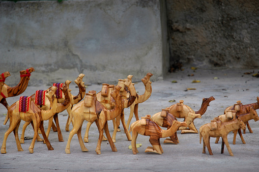 A caravan of wooden souvenir camels for sale by a local vendor in Jerusalem, Israel