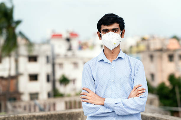 Young man wearing FFP2 Mask to protect from any virus or pollution. Young man wearing FFP2 Mask to protect from any virus or pollution. COVID-19 Pandemic Coronavirus protection. person wearing n95 mask stock pictures, royalty-free photos & images