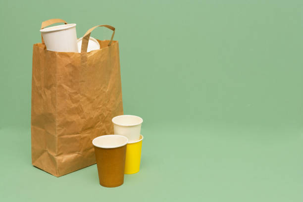 istock Paper garbage collected in a paper bag. Green background. 1251637613