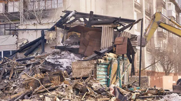 Photo of Demolition house using excavator in city. Rebuilding process. Remove equipment