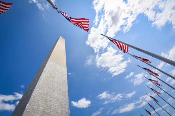 istock US national Flag at Washington Monument in DC 1251649692