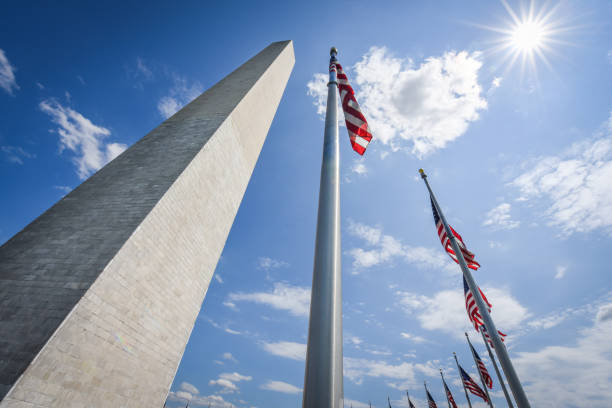 istock US national Flag at Washington Monument in DC 1251649696