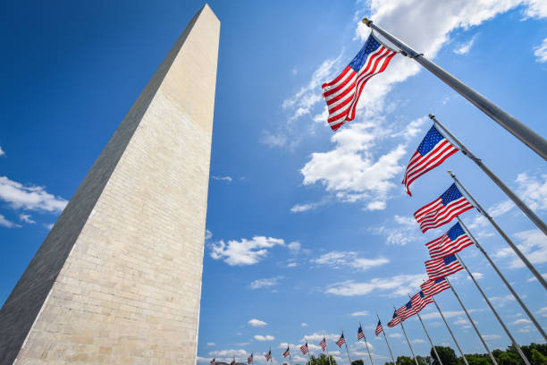 istock US national Flag at Washington Monument in DC 1251649904