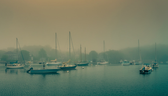 Mystic pastel-colored idyllic landscape over the harbor on Cape Cod in June