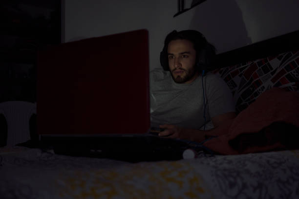 istock Man playing video games at home spending quarantine on COVID-19 1251650811