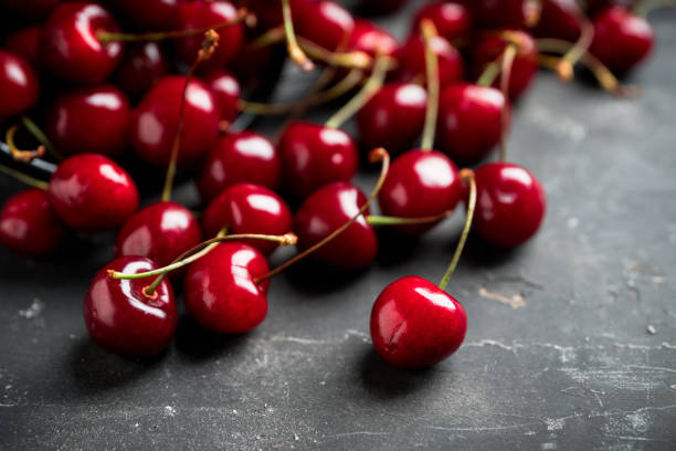 istock Ripe and juicy cherries on the dark rustic background 1251652954