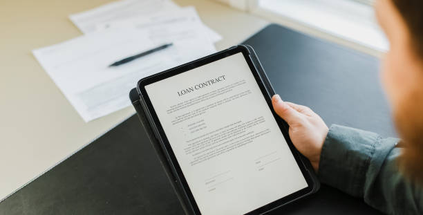 istock Businessman signing loan contract on tablet 1251657756