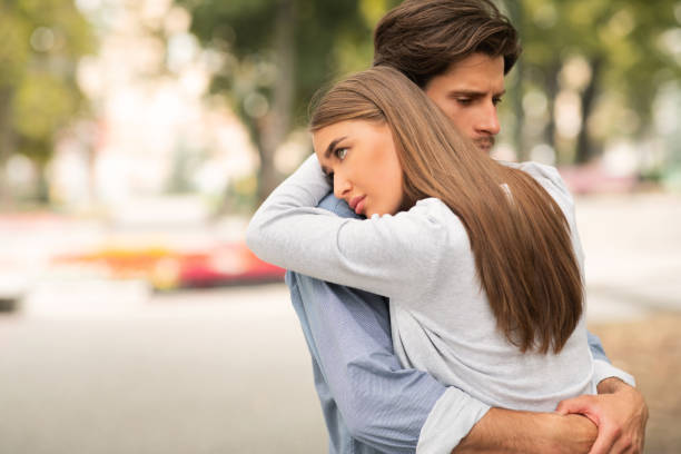 istock Sad Guy And Girl Hugging Feeling Unloved Standing Outdoors 1251663408