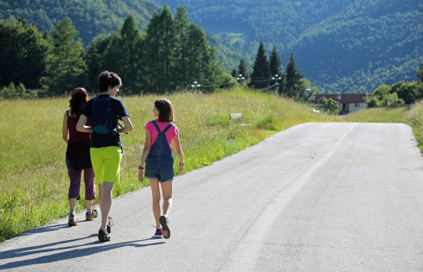 istock mother with two young children while walking 1251664505