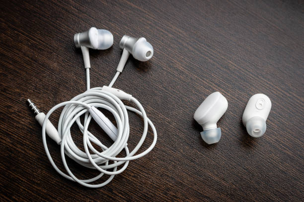 istock white wireless bluetooth headphones and wired tangled headphones close-up 1251665905