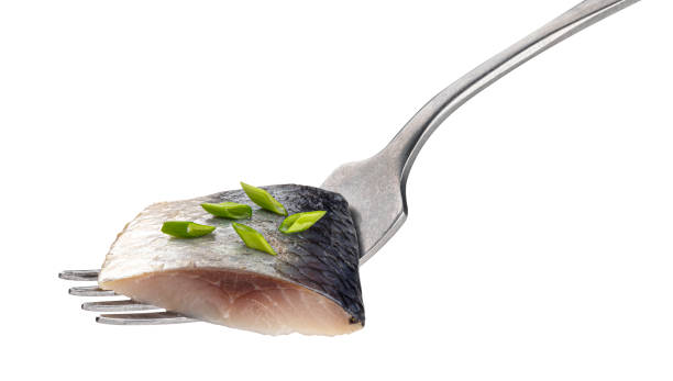 istock Pieces of salted herring on fork isolated on white background 1251666737