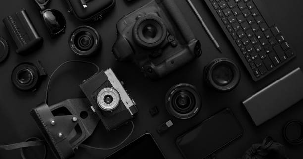 istock hotographer workspace concept. Various digital and analog gadgets placed on black background 1251674301