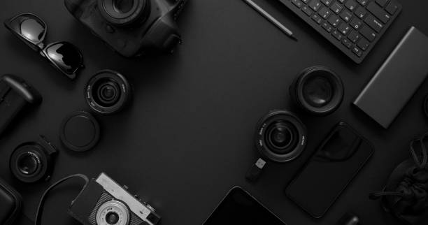 istock hotographer workspace concept. Various digital and analog gadgets placed on black background 1251674317