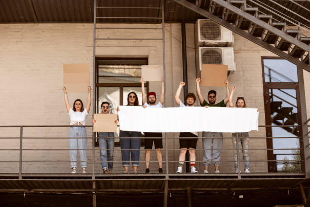 istock Diverse group of people protesting with blank signs. Protest against human rights, abuse of freedom, social issues 1251674987