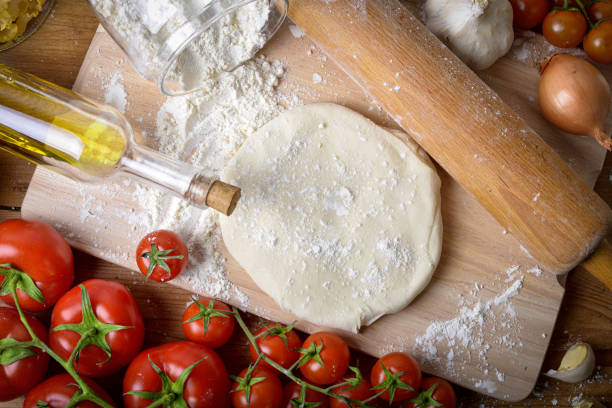istock an homemade pizza dough with onions and fresh tomatoes 1251676652